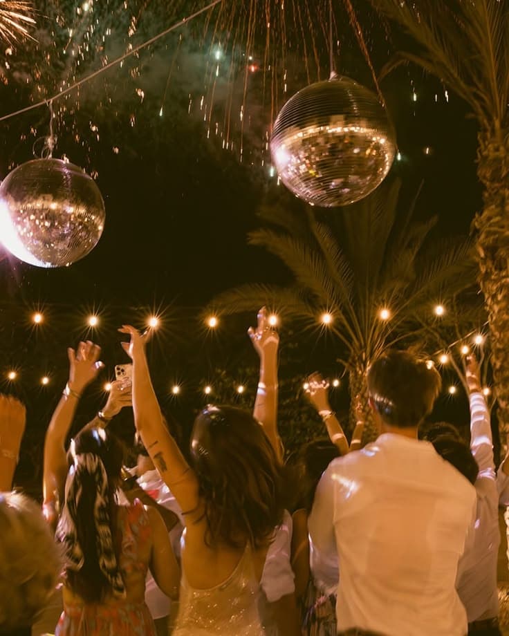 Guests celebrating under string lights