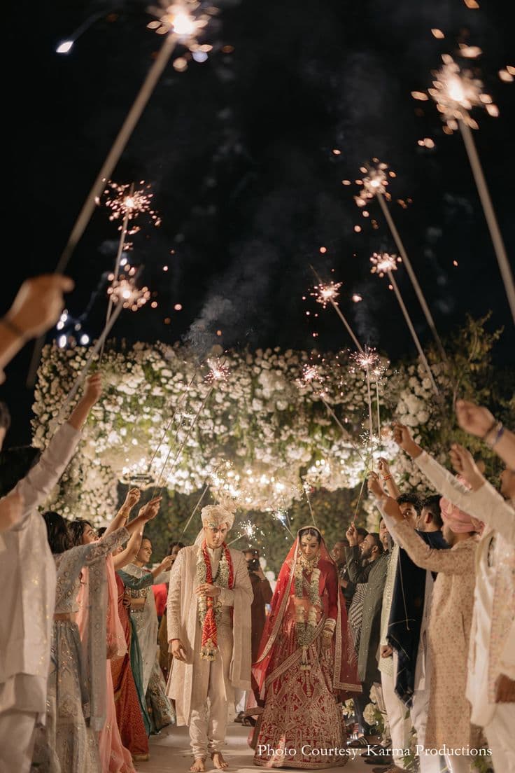 Couple under a floral wedding arch